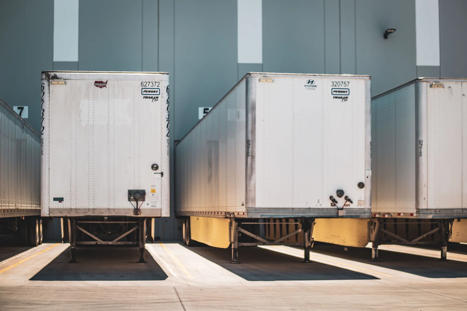Real industry photograph of freight trailers lined up at a commercial loading dock
